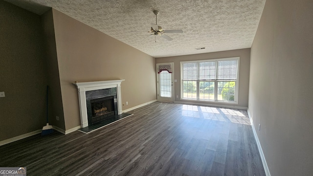 unfurnished living room with ceiling fan, dark hardwood / wood-style flooring, and a textured ceiling