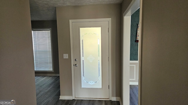 entryway featuring a textured ceiling and dark hardwood / wood-style flooring