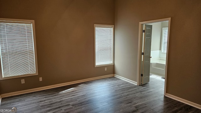 unfurnished room with dark hardwood / wood-style flooring