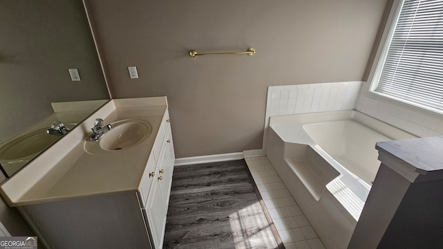 bathroom with vanity, a bathing tub, and tile patterned flooring