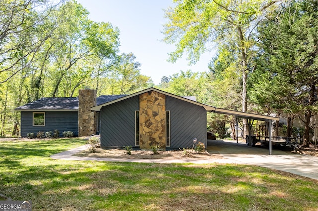 exterior space featuring a yard and a carport