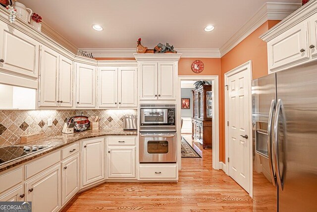 kitchen with ornamental molding, light hardwood / wood-style flooring, backsplash, stainless steel fridge with ice dispenser, and cooktop