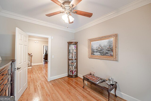 interior space with ornamental molding and light hardwood / wood-style flooring