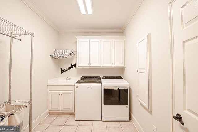 clothes washing area featuring light tile patterned floors, separate washer and dryer, cabinets, and ornamental molding