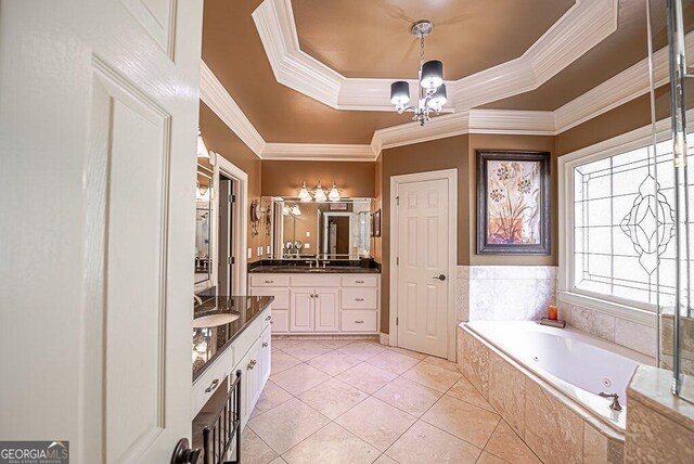 bathroom with vanity, crown molding, a tray ceiling, tile patterned flooring, and tiled bath