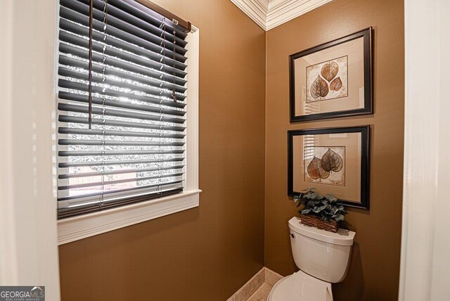 bathroom with ornamental molding and toilet