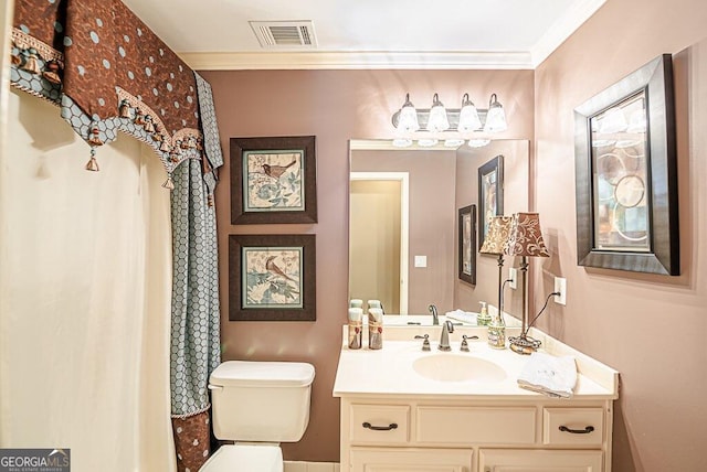 bathroom with ornamental molding, toilet, and vanity