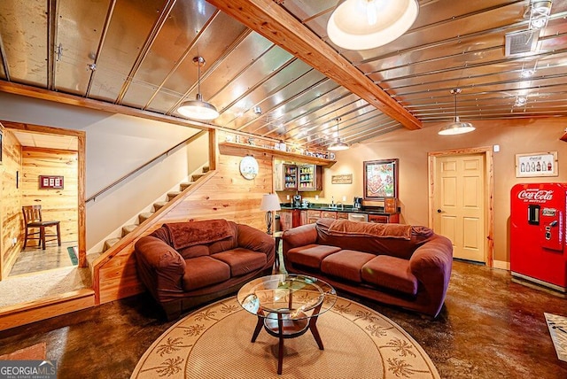 living room featuring vaulted ceiling with beams, wooden walls, and bar