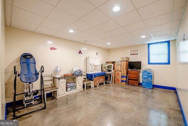 basement with a paneled ceiling