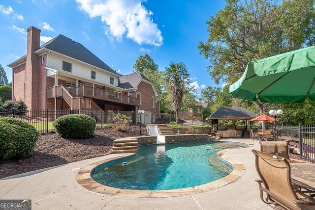 view of pool with a deck and a patio