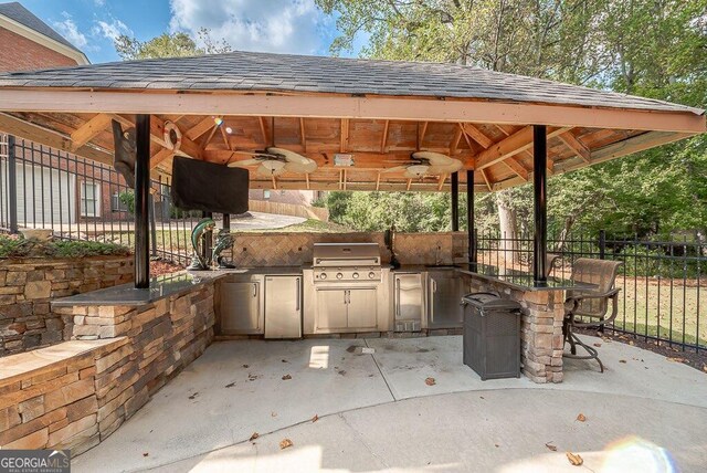 view of patio featuring a gazebo, area for grilling, ceiling fan, and a grill