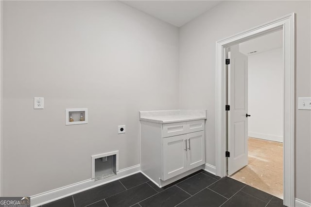 washroom with washer hookup, dark tile patterned flooring, and hookup for an electric dryer