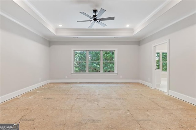 unfurnished room featuring ceiling fan, a tray ceiling, and crown molding