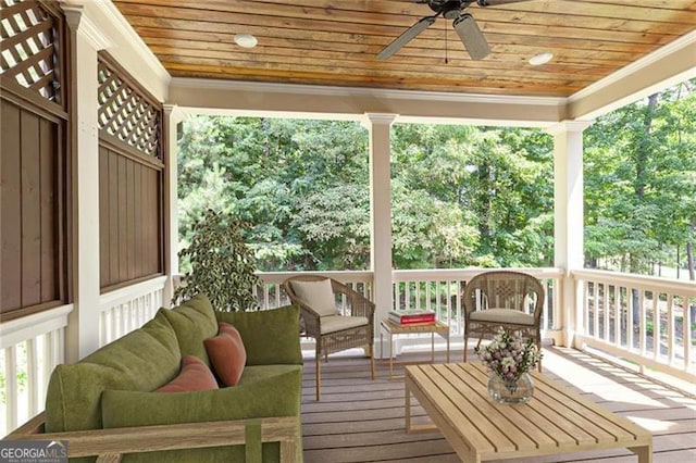 sunroom with ornate columns, ceiling fan, and wooden ceiling