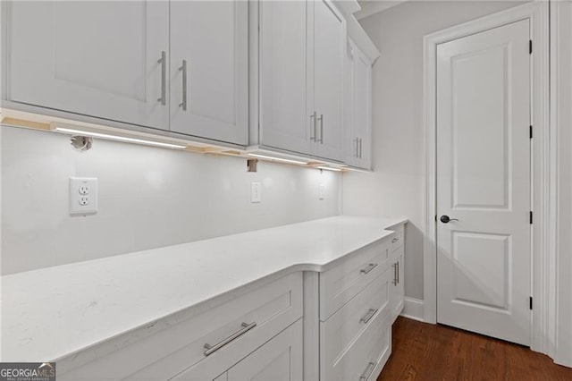 clothes washing area featuring dark hardwood / wood-style floors