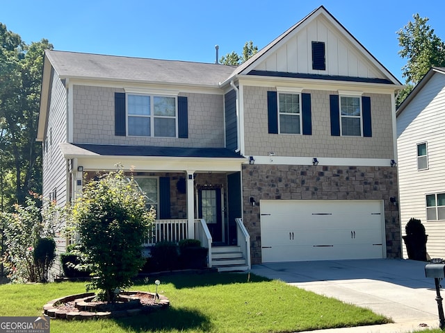 view of front of home with a garage, a porch, and a front yard