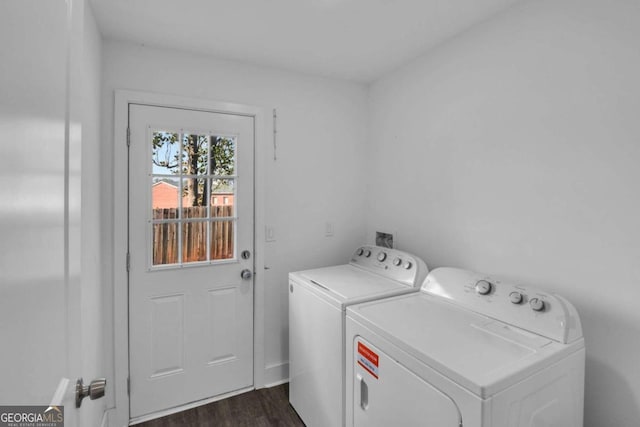 laundry area with dark wood-type flooring and washer and clothes dryer