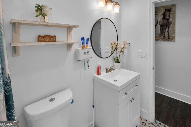 bathroom featuring hardwood / wood-style floors, vanity, and toilet