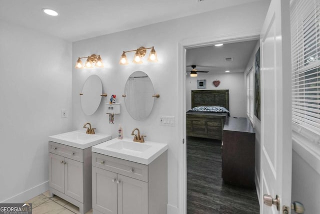 bathroom featuring ceiling fan, vanity, and wood-type flooring