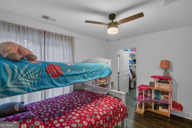 bedroom featuring ceiling fan, a closet, and dark hardwood / wood-style flooring