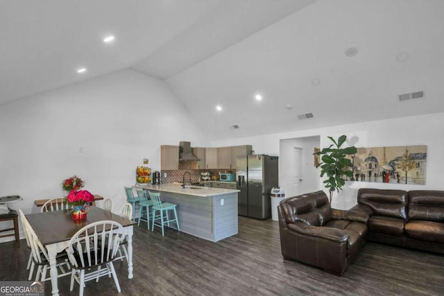 living room featuring lofted ceiling, sink, and dark hardwood / wood-style flooring