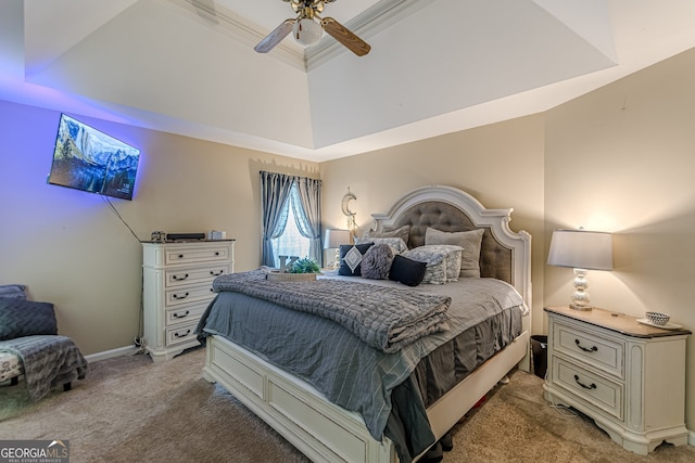 bedroom featuring ceiling fan, light carpet, and a tray ceiling