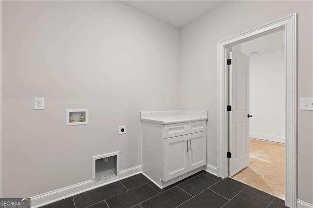 laundry room featuring washer hookup, dark tile patterned flooring, and electric dryer hookup