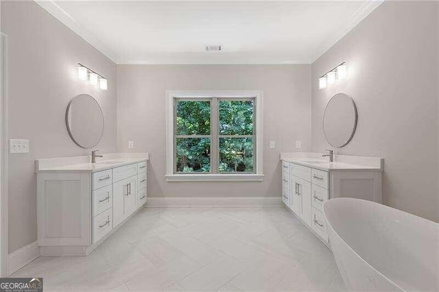 bathroom with ornamental molding, vanity, and a bathing tub