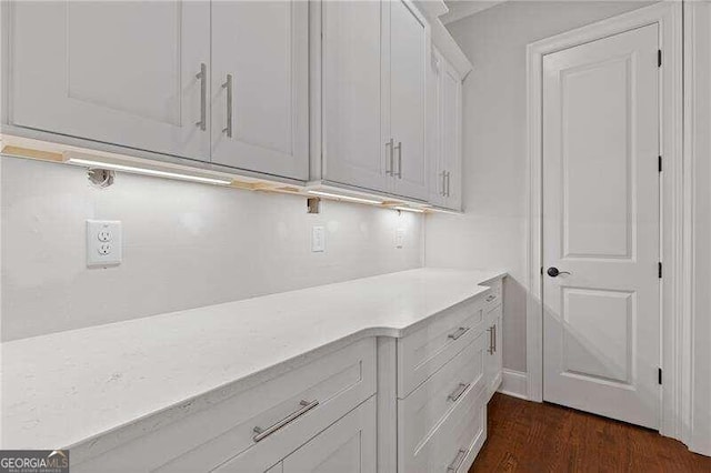 laundry area featuring dark wood-type flooring