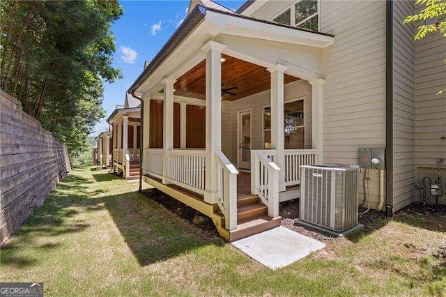 view of home's exterior featuring cooling unit, a yard, and ceiling fan