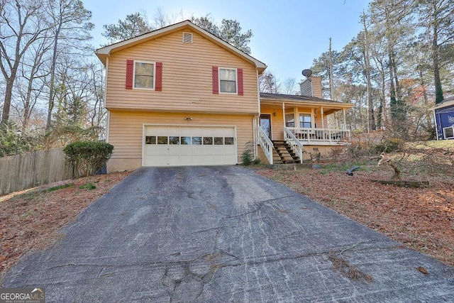 split level home featuring a garage and a porch