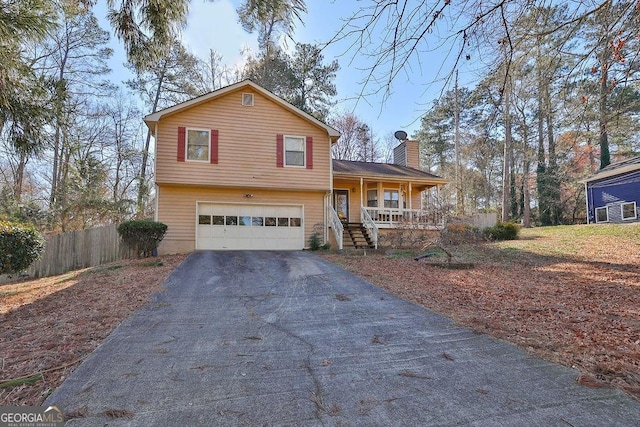 split level home featuring covered porch and a garage