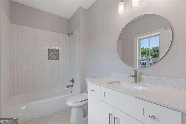 full bathroom featuring tile patterned flooring, tiled shower / bath combo, vanity, and toilet