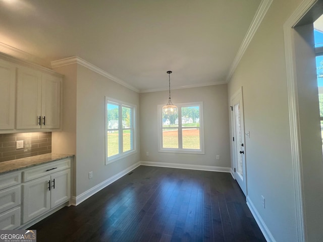 unfurnished dining area with ornamental molding and dark hardwood / wood-style flooring