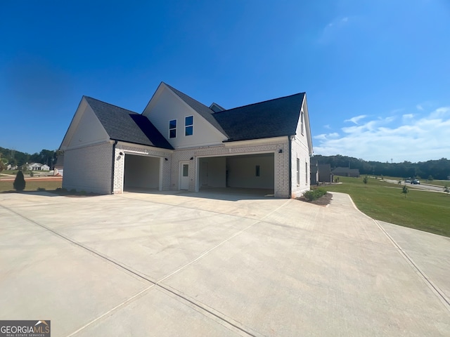 view of property exterior featuring a garage and a lawn