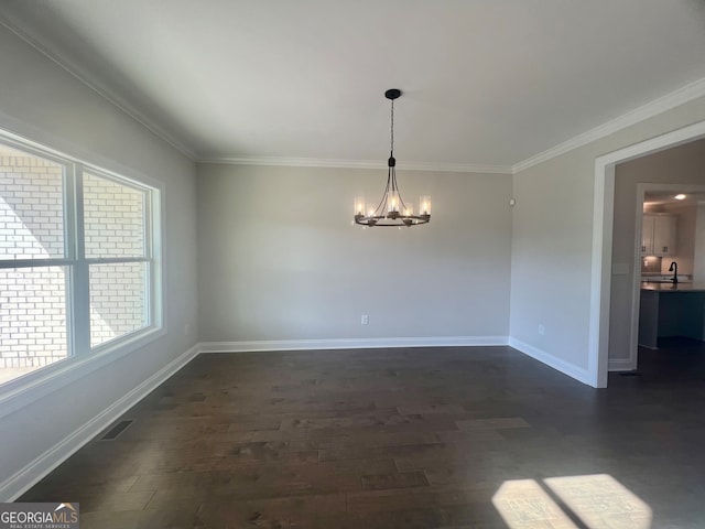 unfurnished dining area featuring a notable chandelier, crown molding, dark wood-type flooring, and sink