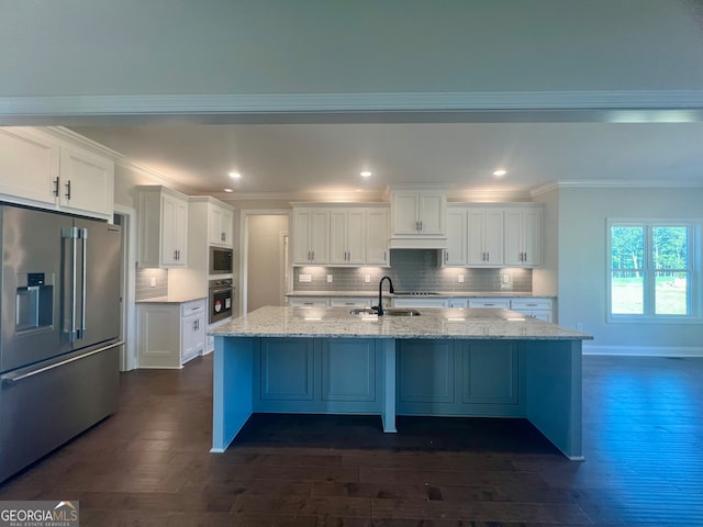 kitchen with stainless steel appliances, a center island with sink, dark hardwood / wood-style flooring, and white cabinetry