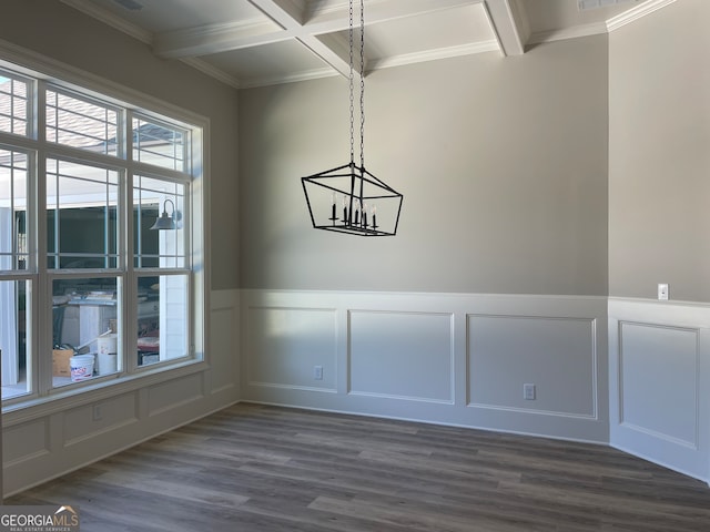 unfurnished dining area with beamed ceiling, a chandelier, coffered ceiling, dark hardwood / wood-style floors, and ornamental molding