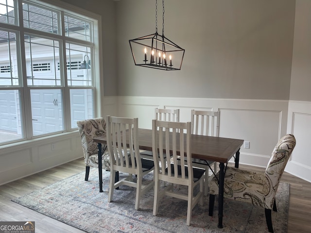 dining room featuring hardwood / wood-style flooring and a notable chandelier