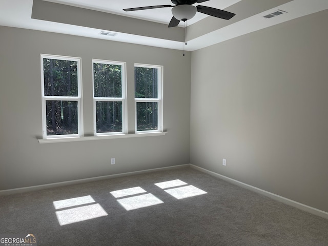 carpeted spare room with ceiling fan