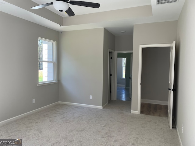 carpeted empty room featuring ceiling fan