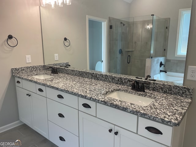 bathroom featuring vanity, shower with separate bathtub, and tile patterned floors