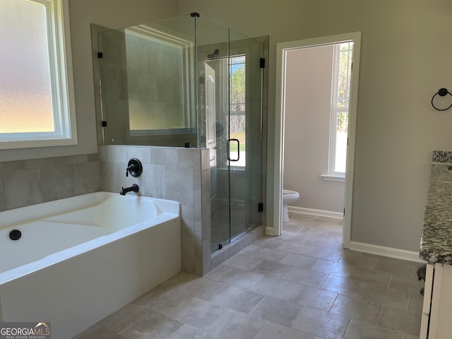 bathroom with a wealth of natural light, tile patterned flooring, toilet, and plus walk in shower