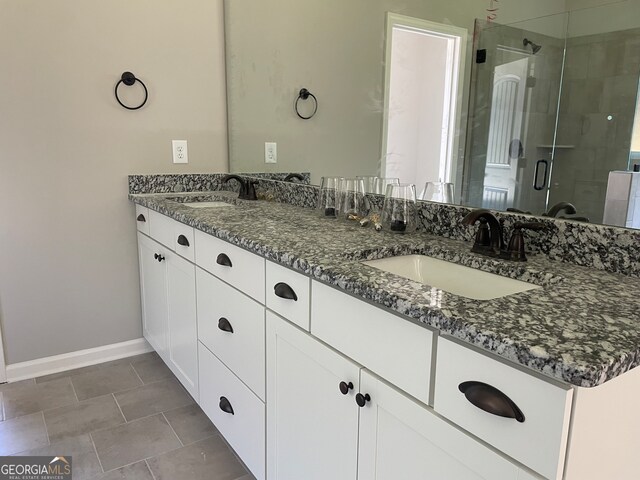 bathroom with vanity, tile patterned flooring, and an enclosed shower