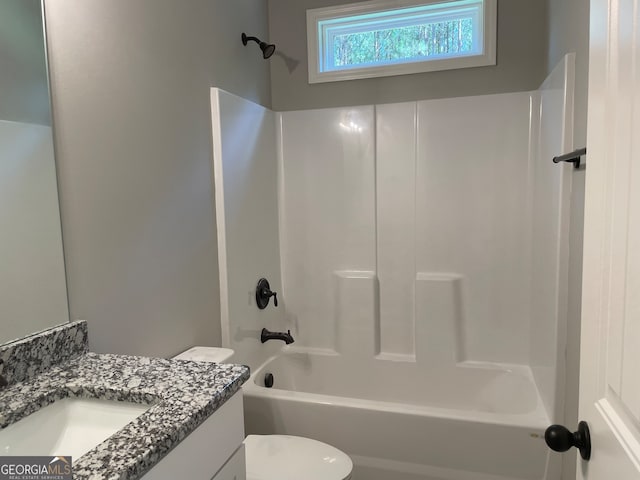 full bathroom featuring tub / shower combination, vanity, and toilet