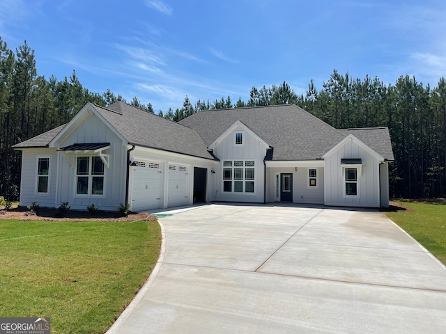 modern farmhouse style home with a front lawn and a garage