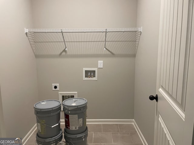 laundry room featuring washer hookup, dark tile patterned floors, and electric dryer hookup