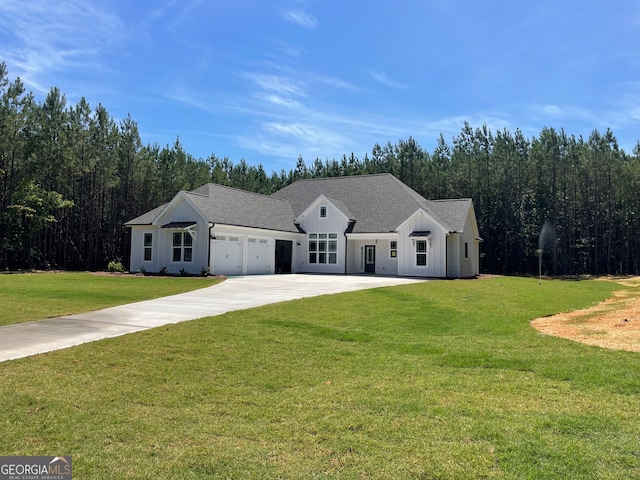 view of front of home with a front yard and a garage