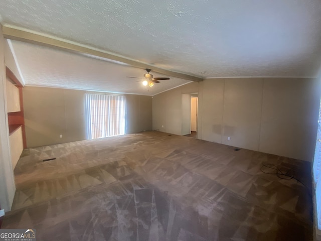 unfurnished room with carpet floors, ceiling fan, lofted ceiling with beams, and a textured ceiling