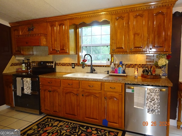 kitchen featuring sink, dishwasher, backsplash, black electric range, and light tile patterned floors